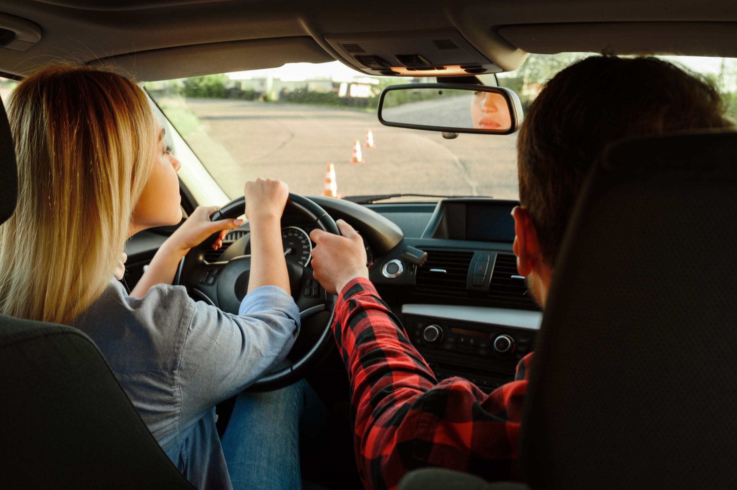 About Us 1 instructor helps woman to drive the car 2021 08 28 20 00 46 utc min scaled