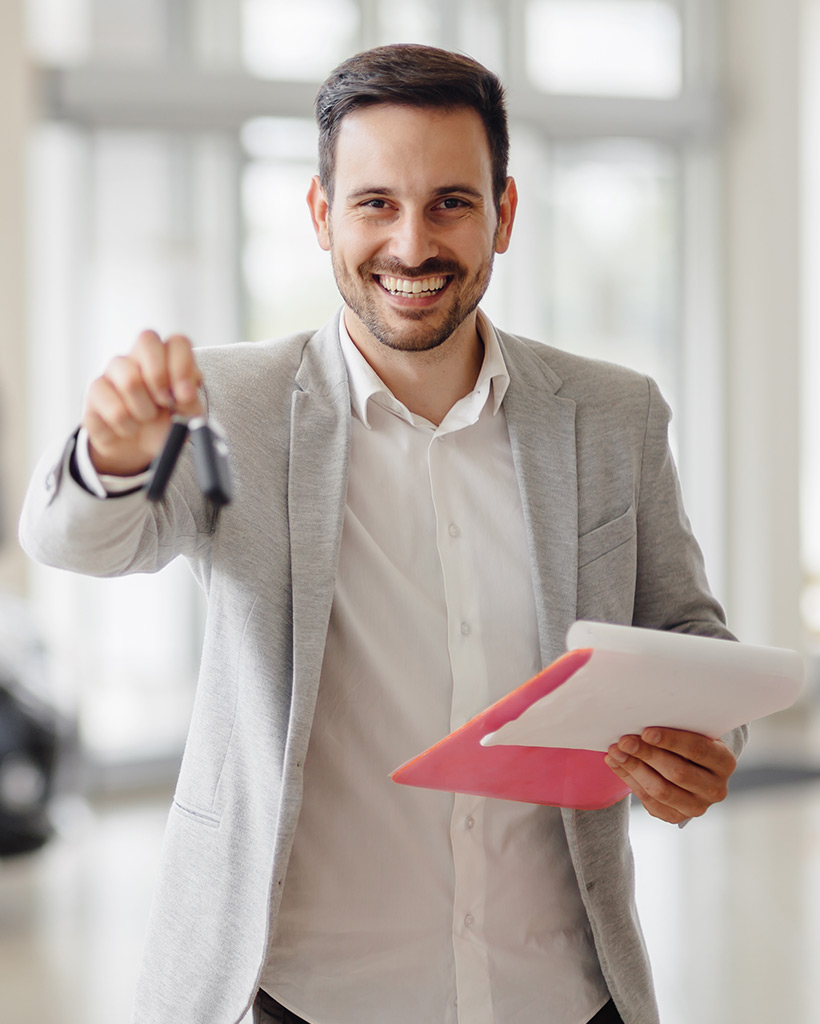 salesperson workin at car dealership RCG2WQP